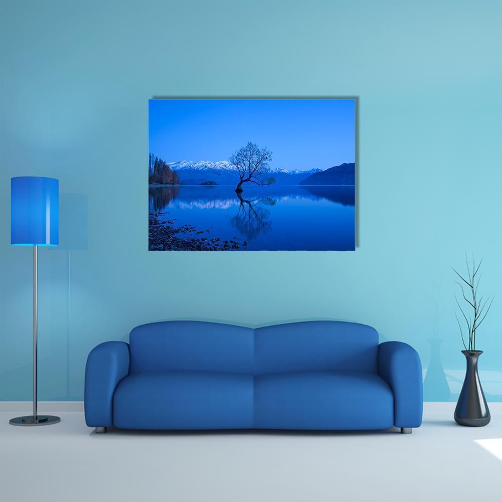 Moonlit Tree Over Lake with Snow-capped Peaks Canvas Wall Art in white, blue and navy, single panel hung on a wall