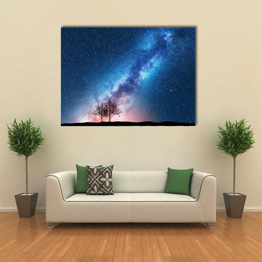 Milky Way Over Silhouetted Trees Canvas Wall Art in black, blue and purple, single panel hung on a wall