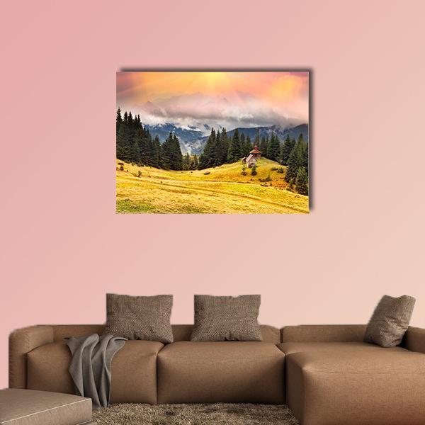 Autumn Chapel on Mountain Meadow Canvas Wall Art in orange, yellow and green, single panel hung on a wall
