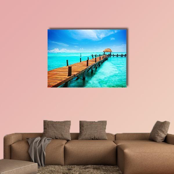 Tropical Jetty with Thatched Hut Canvas Wall Art in white, brown and blue, single panel hung on a wall