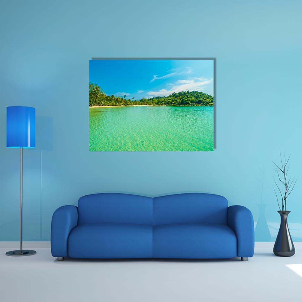 Tropical Beach with Turquoise Water Canvas Wall Art in green and blue, single panel hung on a wall