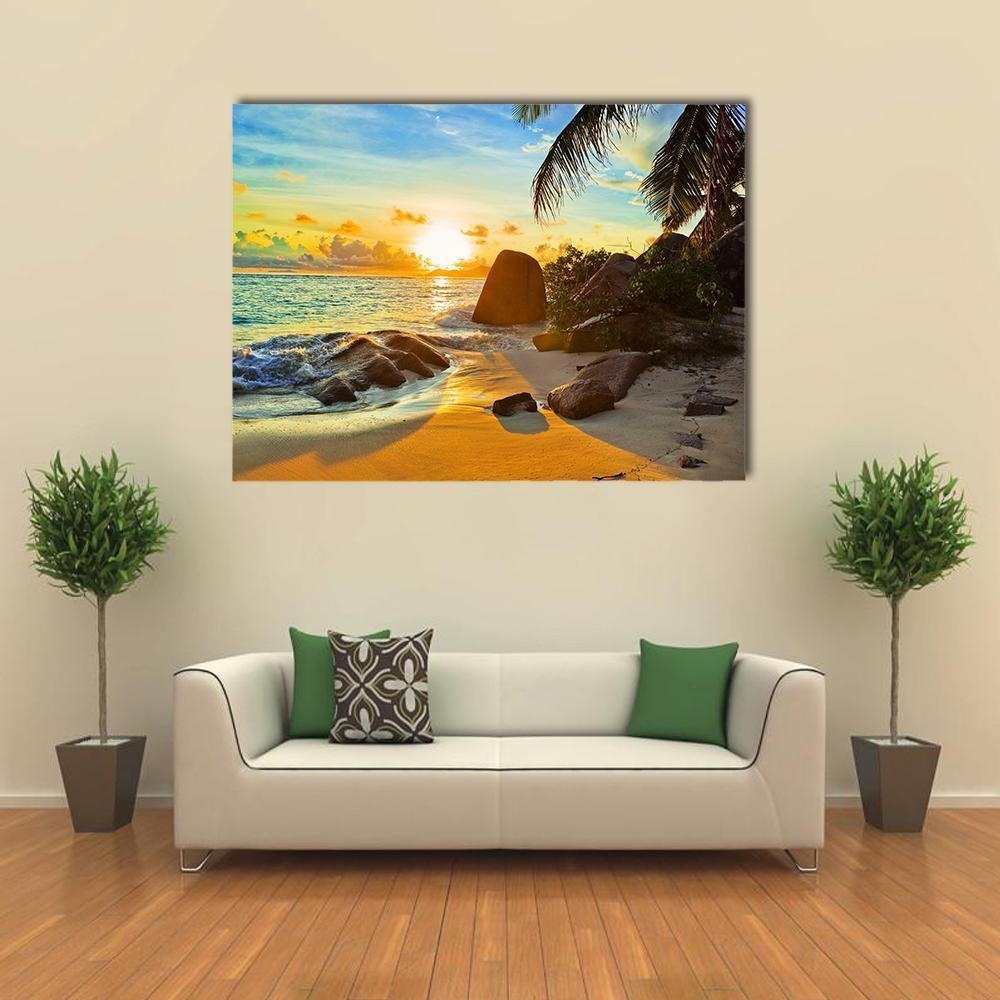 Tropical Beach at Sunset Canvas Wall Art in orange, yellow and blue, single panel hung on a wall