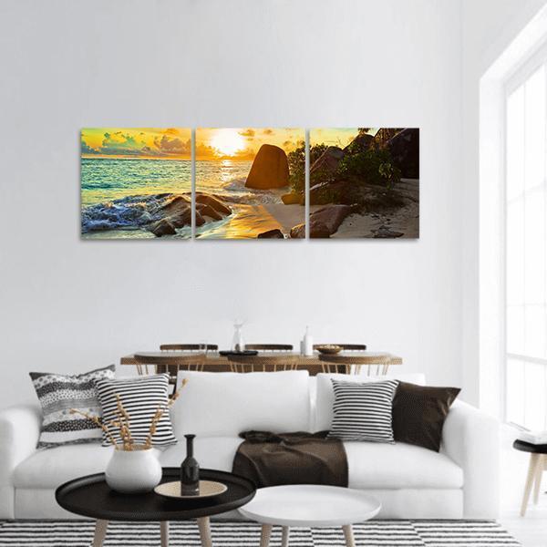 Tropical Beach at Sunset Panoramic Canvas Wall Art in orange, yellow and blue, hung on a wall