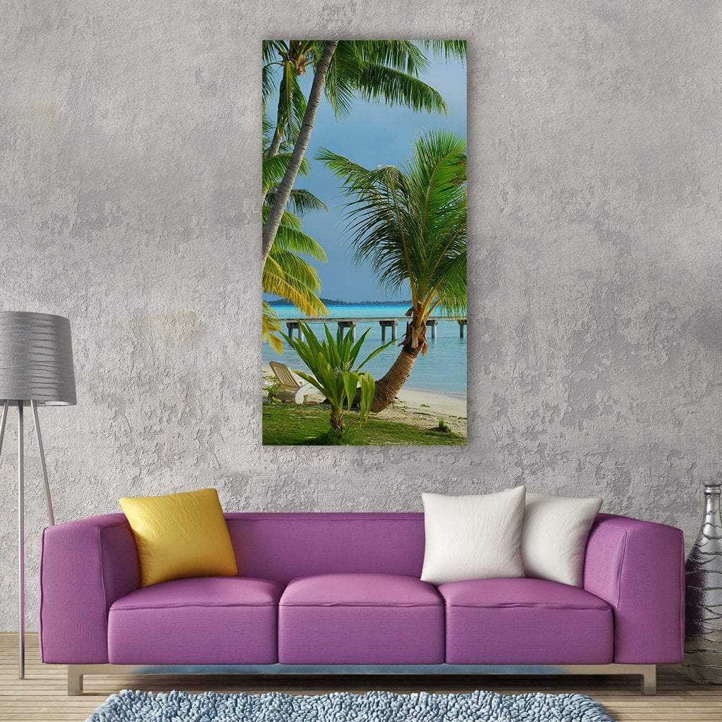 Tropical Beach with Palm Trees and Pier Vertical Canvas Wall Art in green and blue, single vertical panel hung on a wall