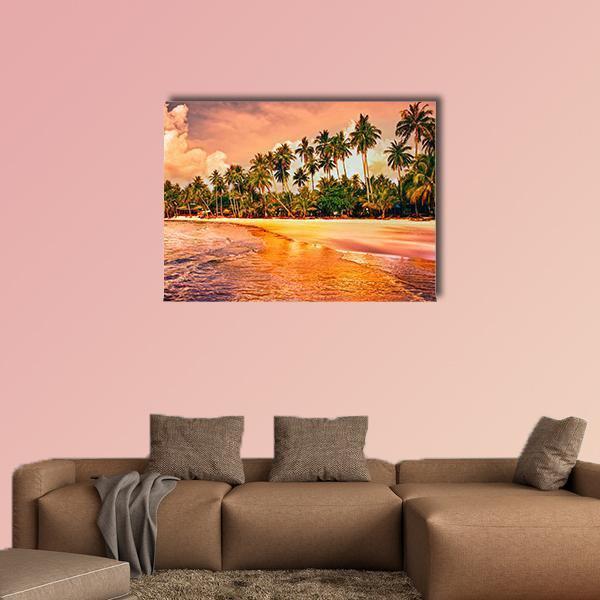 Tropical Beach with Palms at Sunset Canvas Wall Art in orange, yellow and pink, single panel hung on a wall
