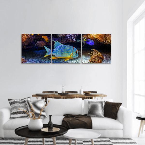 Tropical Fish on Coral Reef Panoramic Canvas Wall Art in black, yellow and blue, hung on a wall