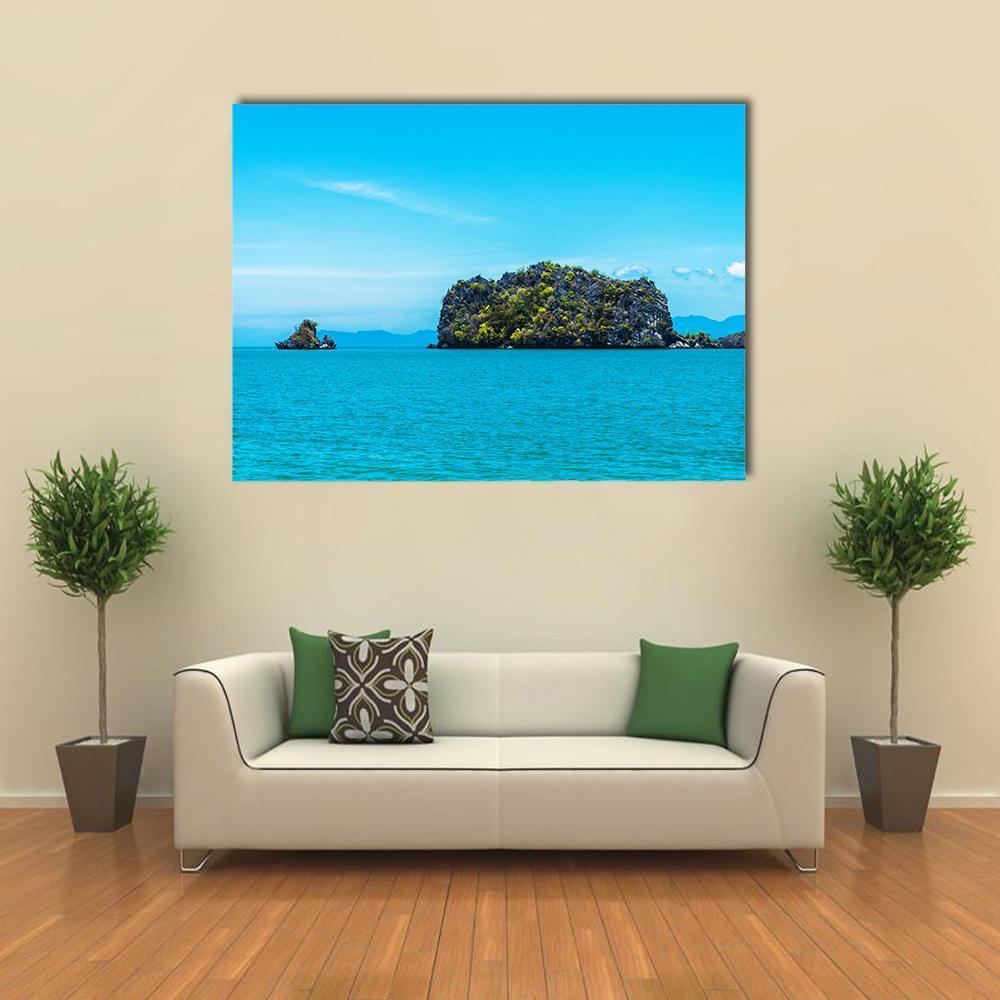 Tropical Island and Turquoise Ocean Canvas Wall Art in green and blue, single panel hung on a wall