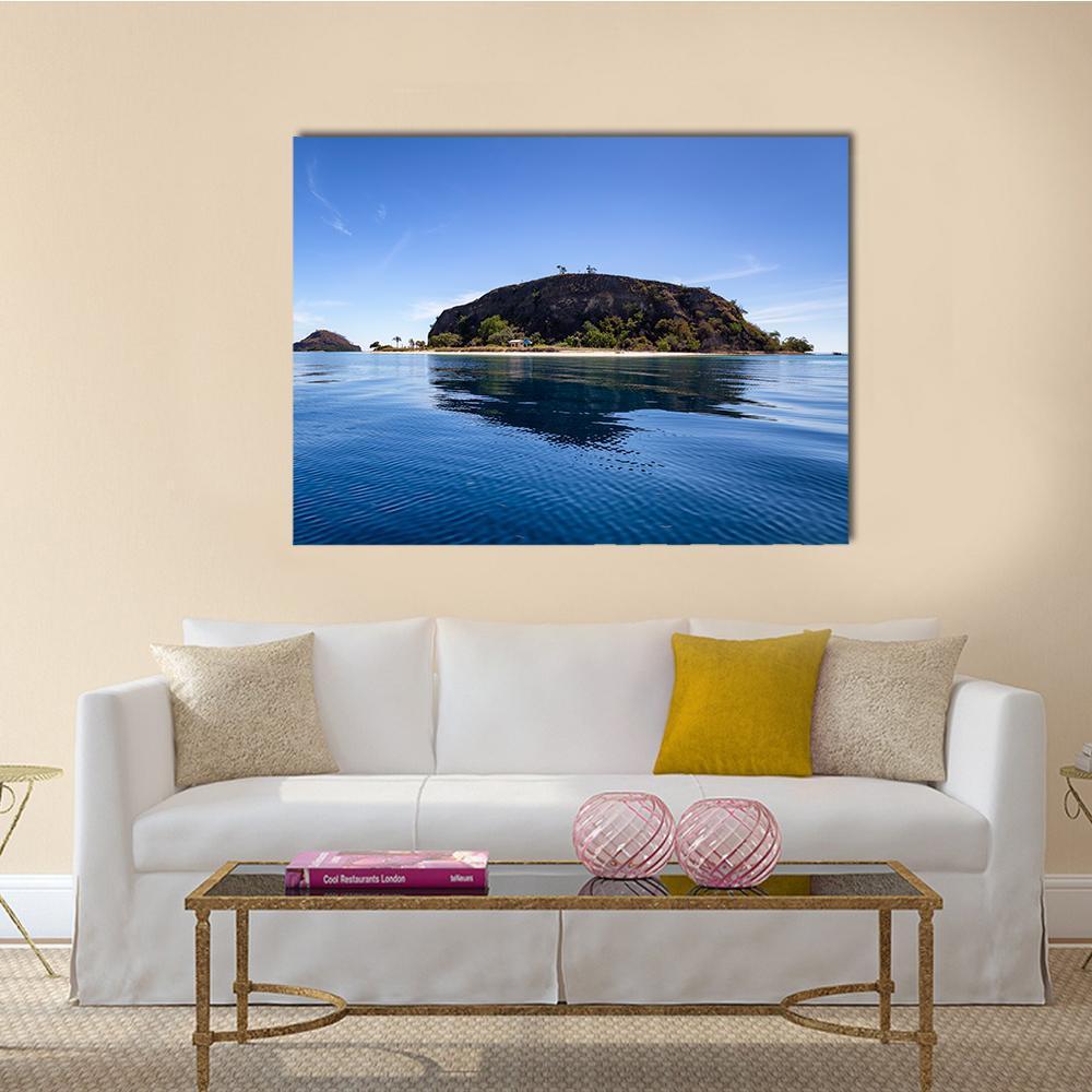 Tropical Island with Small Beach Canvas Wall Art in brown and blue, single panel hung on a wall