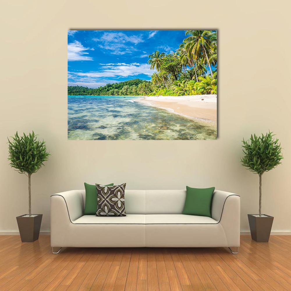 Tropical Island Beach with Palm Trees Canvas Wall Art in beige, green and blue, single panel hung on a wall