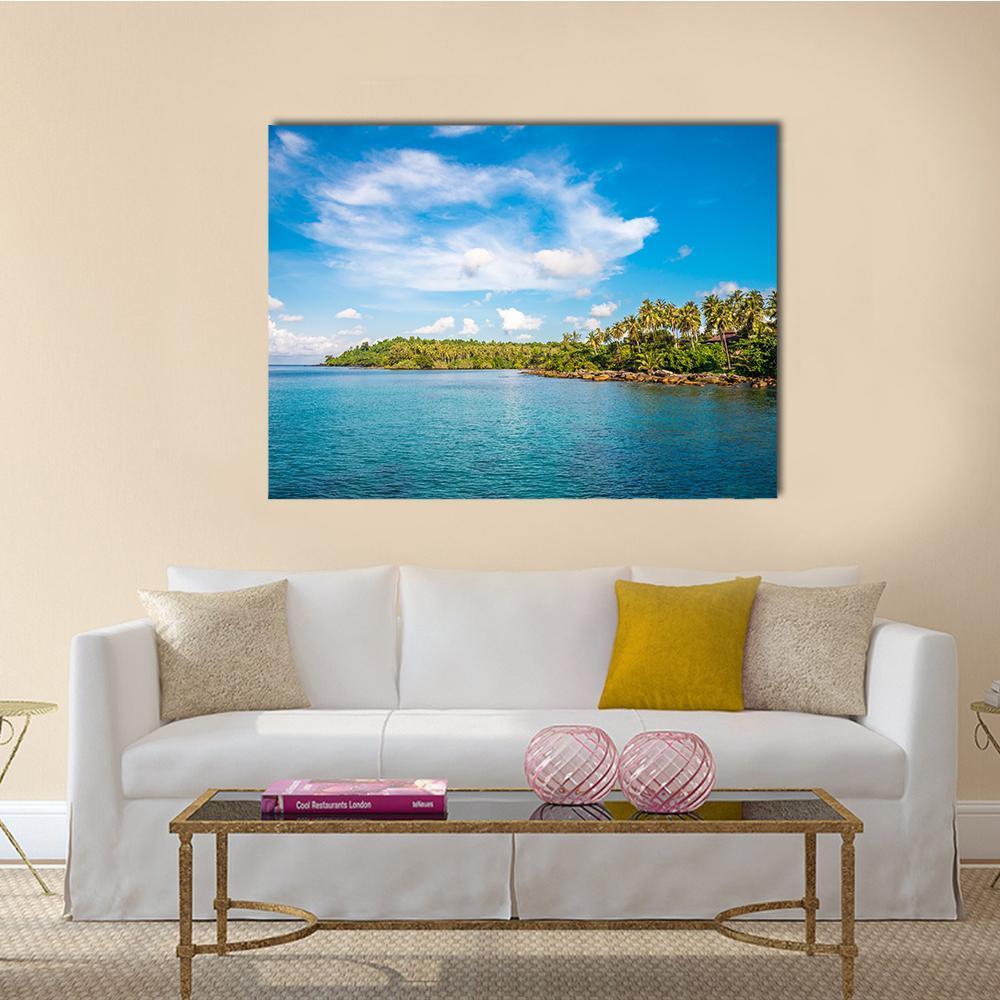 Tropical Island Beach Canvas Wall Art in white, green and blue, single panel hung on a wall