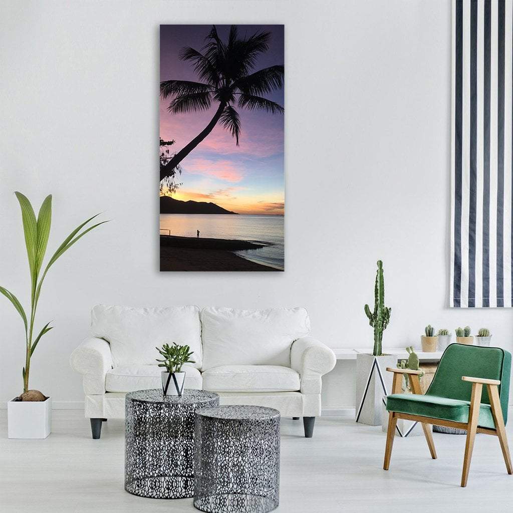 Tropical Palm at Sunset Vertical Canvas Wall Art in orange, blue and purple, single vertical panel hung on a wall