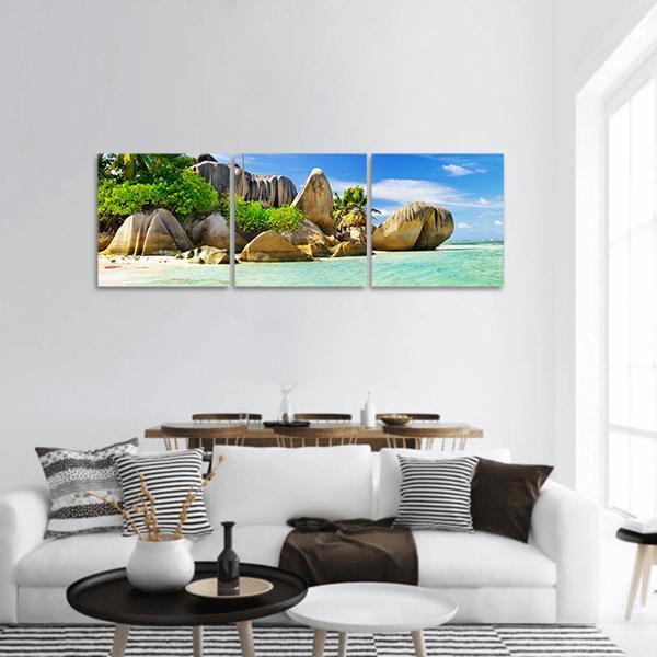 Turquoise Tropical Island Seascape Panoramic Canvas Wall Art in beige, green and blue, hung on a wall