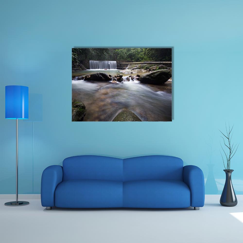 Tropical Rainforest Waterfall Canvas Wall Art in gray, brown and green, single panel hung on a wall