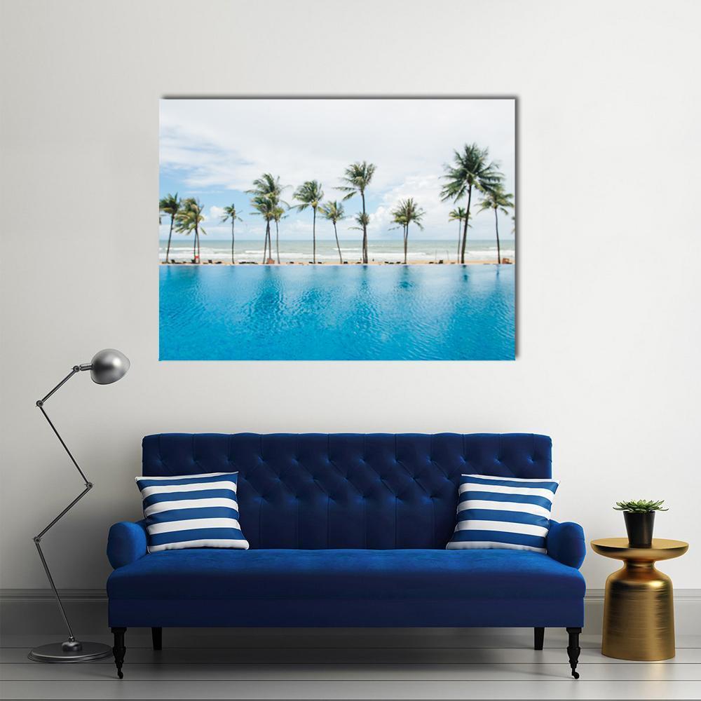 Tropical Beach with Palm Trees and Infinity Pool Canvas Wall Art in white, green and blue, single panel hung on a wall