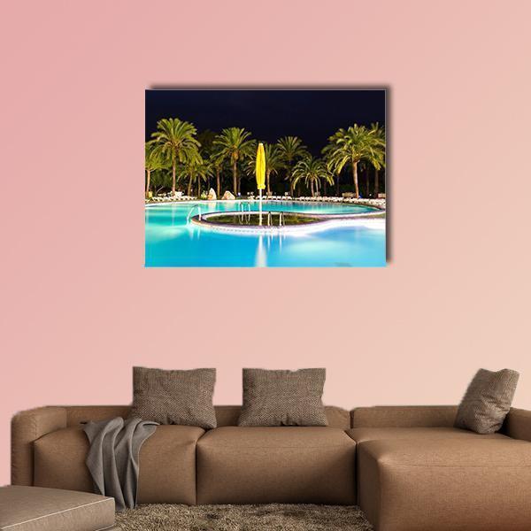 Tropical Night Pool with Yellow Umbrella Canvas Wall Art in black, green and blue, single panel hung on a wall