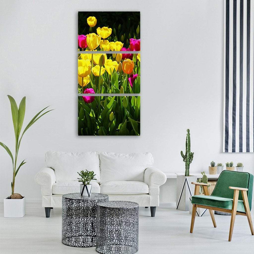 Vibrant Tulip Close-up Vertical Canvas Wall Art in yellow, green and pink, single vertical panel hung on a wall