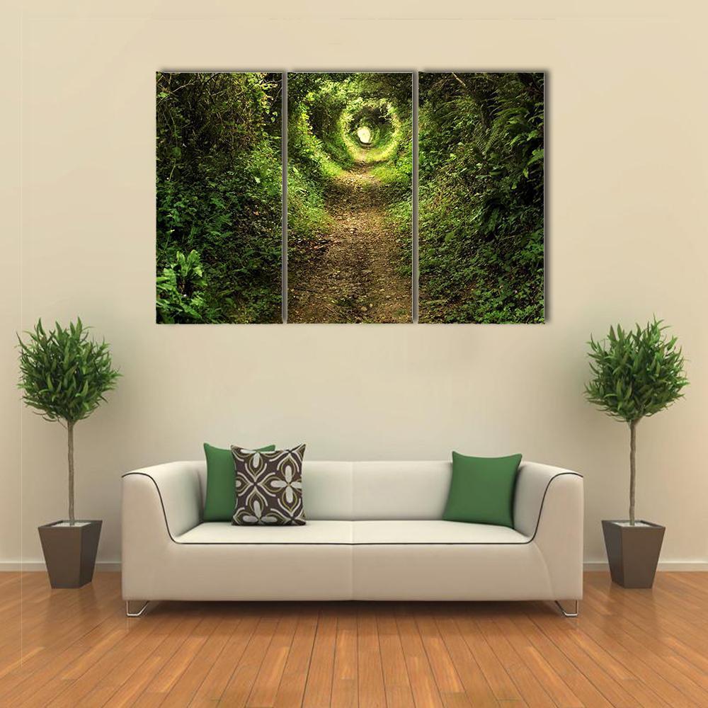 Sunlit Forest Tunnel Path Canvas Wall Art in brown, yellow and green, 3 panel horizontal set hung on a wall