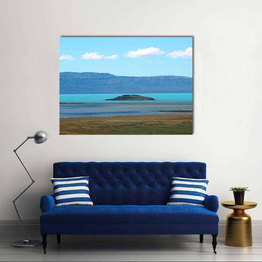 Turquoise Lake with Island and Mountains Canvas Wall Art in gray, brown and blue, single panel hung on a wall