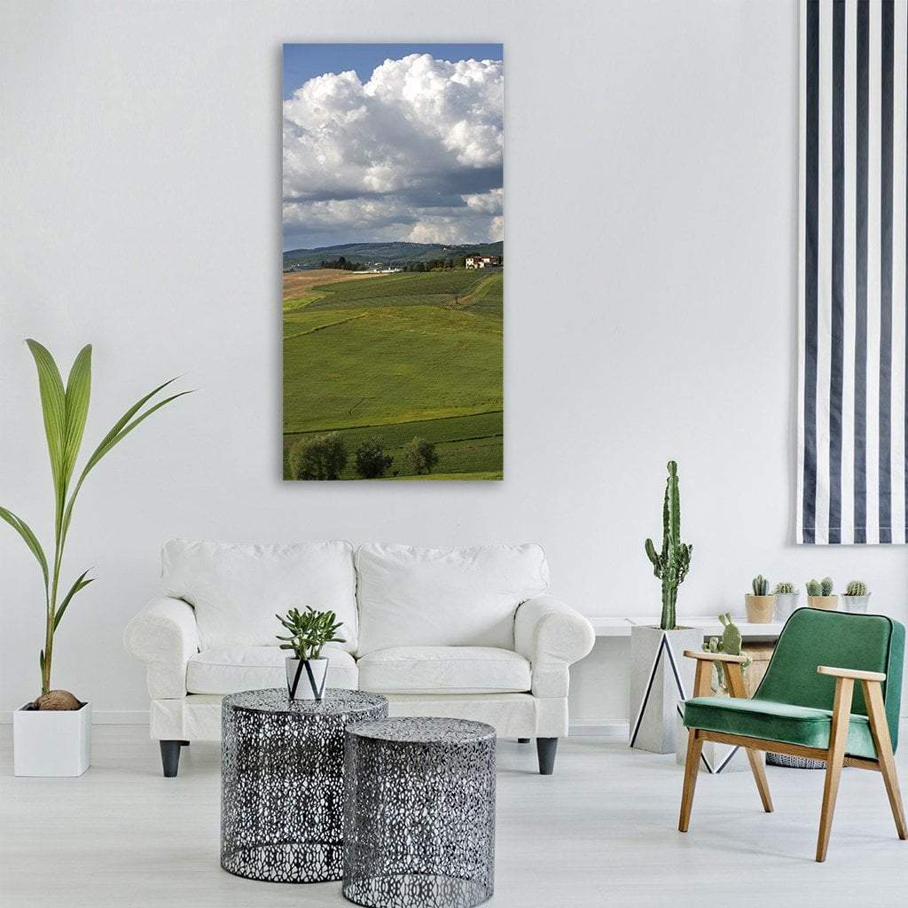 Tuscany Rolling Hills and Fields Vertical Canvas Wall Art in white, green and blue, single vertical panel hung on a wall