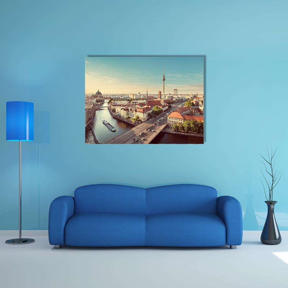 Berlin Tv Tower Over Spree River Canvas Wall Art in orange, yellow and blue, single panel hung on a wall