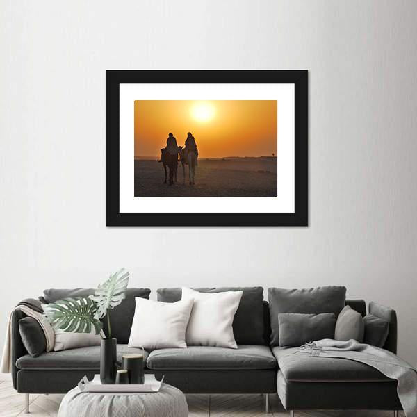 Two Camels Riding Towards Sun In Desert Canvas Wall Art-1 Piece-Framed Print-20" x 16"-Tiaracle