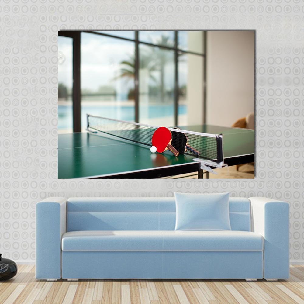 Table Tennis Rackets on Table Canvas Wall Art in black, red and green, single panel hung on a wall