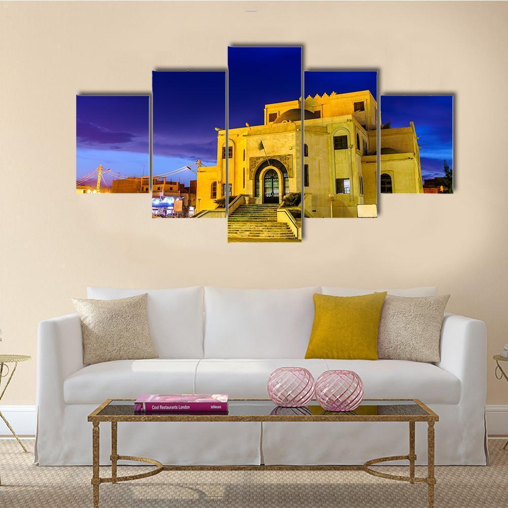 Illuminated Algerian Mosque at Dusk Canvas Wall Art in beige, yellow and blue, 5 panel Star layout hung on a wall