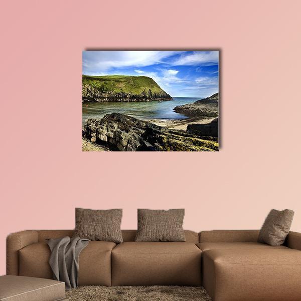 Rocky Green Cliffs by Ocean Bay Canvas Wall Art in brown, green and blue, single panel hung on a wall