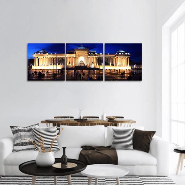 Ulaanbaatar National Museum at Night Panoramic Canvas Wall Art in black, yellow and blue, hung on a wall