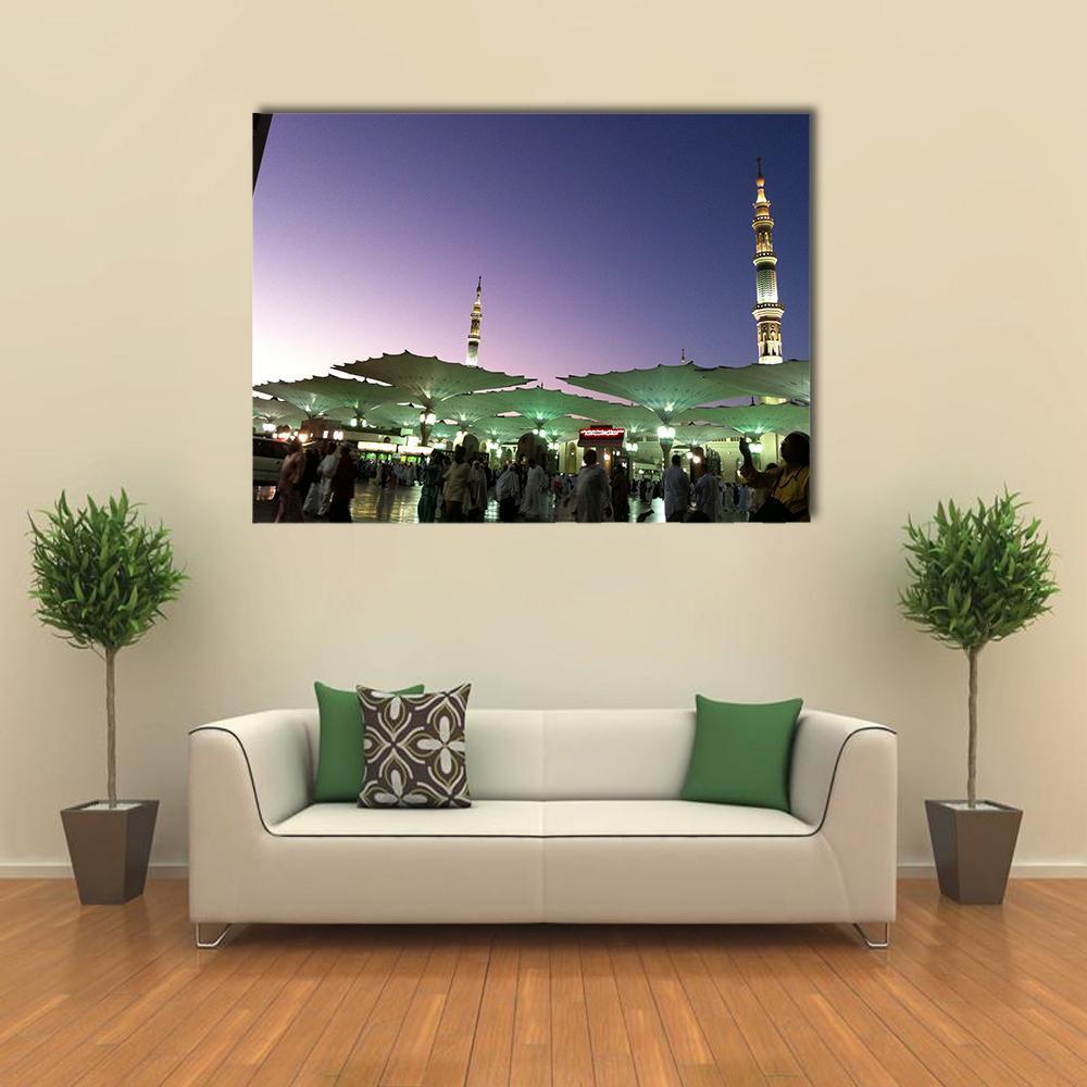 Umbrellas at An-nabawi Mosque Canvas Wall Art in green, blue and purple, single panel hung on a wall