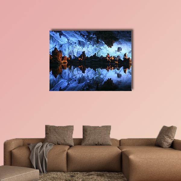 Underground Lake in Reed Flute Cave Canvas Wall Art in black, orange and blue, single panel hung on a wall