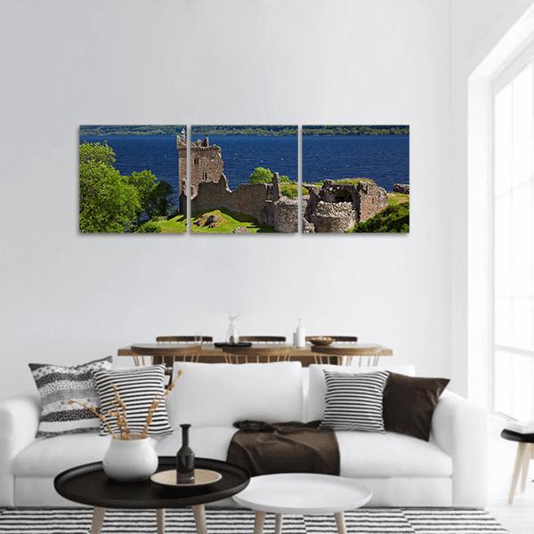 Urquhart Castle Beside Loch Ness Panoramic Canvas Wall Art in gray, green and blue, hung on a wall