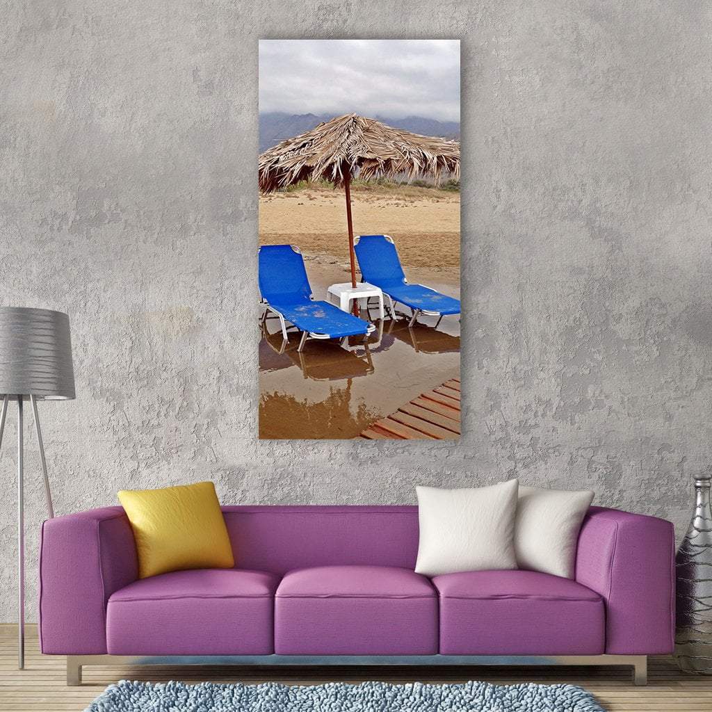 Two Blue Lounge Chairs on Beach Vertical Canvas Wall Art in gray, beige and blue, single vertical panel hung on a wall