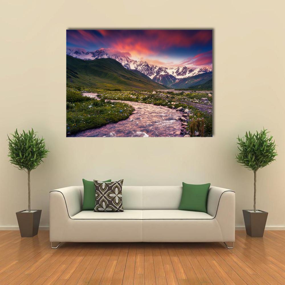 Mt Shkhara Sunset Over River Valley Canvas Wall Art in green, purple and pink, single panel hung on a wall