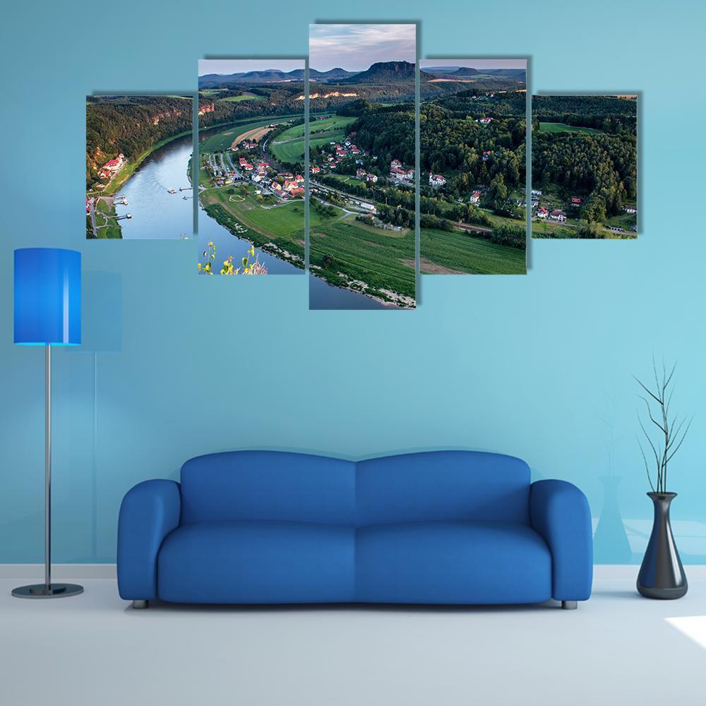 Evening River Valley with Red-roof Village Canvas Wall Art in green and blue, 5 panel Star layout hung on a wall