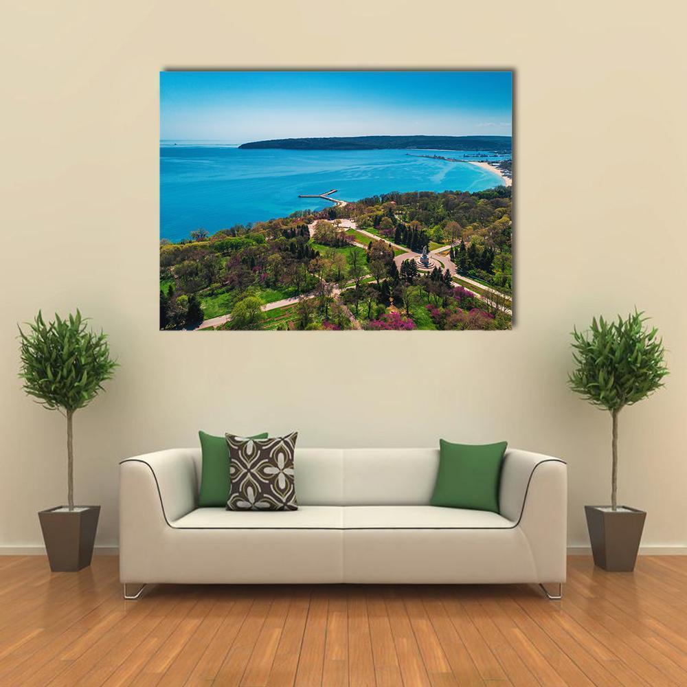 Coastal Park with Pier Aerial View Canvas Wall Art in green and blue, single panel hung on a wall