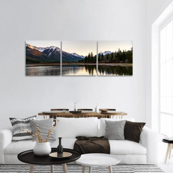 Spring Mountain Lake Reflection Panoramic Canvas Wall Art in white, gray and blue, hung on a wall