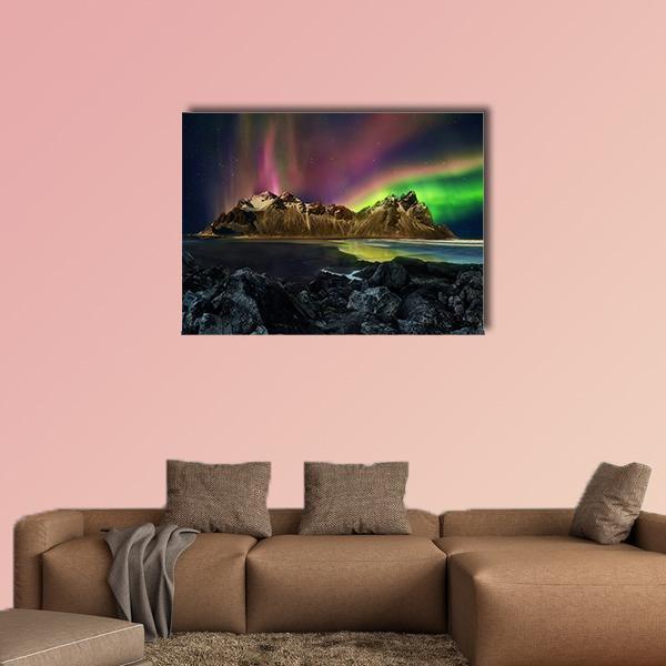 Aurora Over Snow-capped Mountains Canvas Wall Art in black, green and purple, single panel hung on a wall