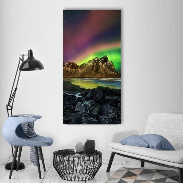 Vestrahorn Under Northern Lights Vertical Canvas Wall Art in black, green and purple, single vertical panel hung on a wall