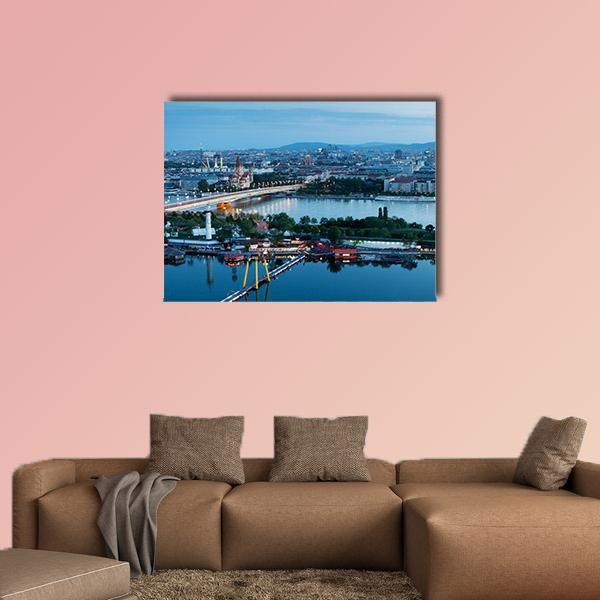Vienna Night Skyline Over River Canvas Wall Art in blue, single panel hung on a wall