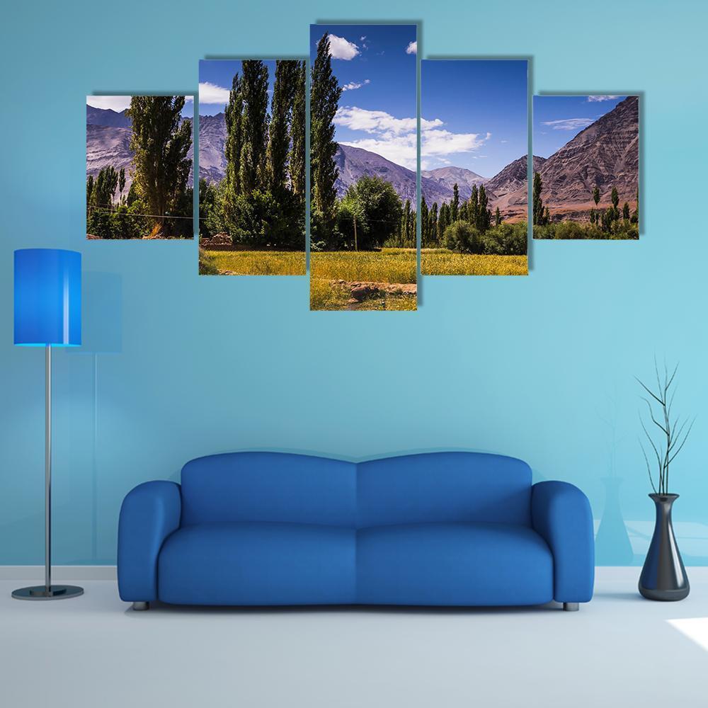 Road Along Poplar Fields in Leh Ladakh Canvas Wall Art in yellow, green and blue, 5 panel Star layout hung on a wall