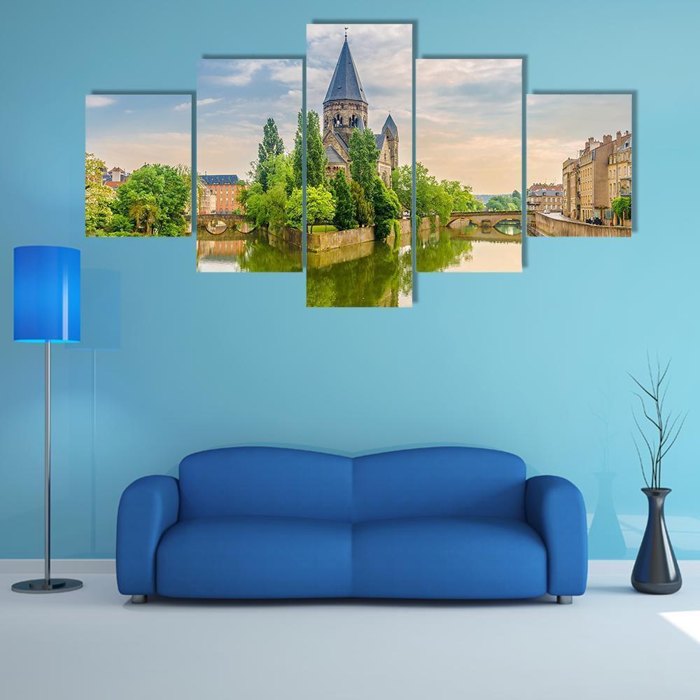 Neuf Temple France Canvas Wall Art in yellow, green and blue, 5 panel Star layout hung on a wall