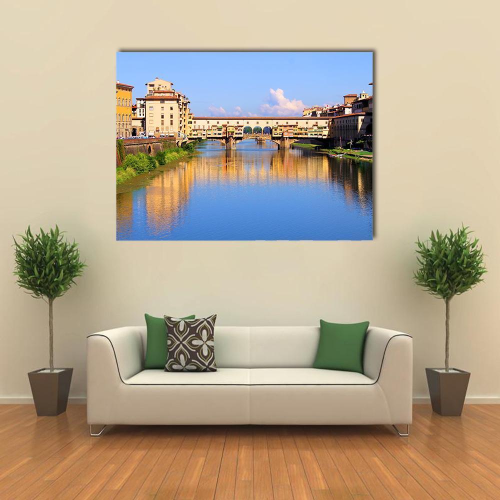 Ponte Vecchio on the Arno River Canvas Wall Art in orange, yellow and blue, single panel hung on a wall