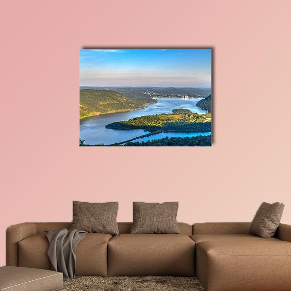 Bridge Over River in Green Hills Canvas Wall Art in green and blue, single panel hung on a wall