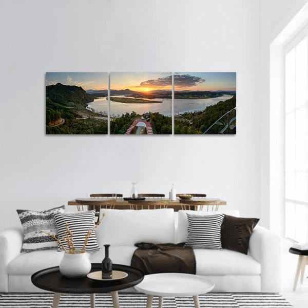Observatory Overlooking River Valley at Sunset Panoramic Canvas Wall Art in orange, green and blue, hung on a wall