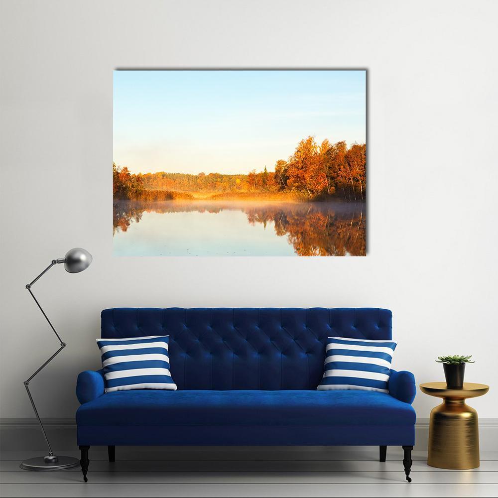 Misty Lake at Dawn Canvas Wall Art in orange, yellow and blue, single panel hung on a wall