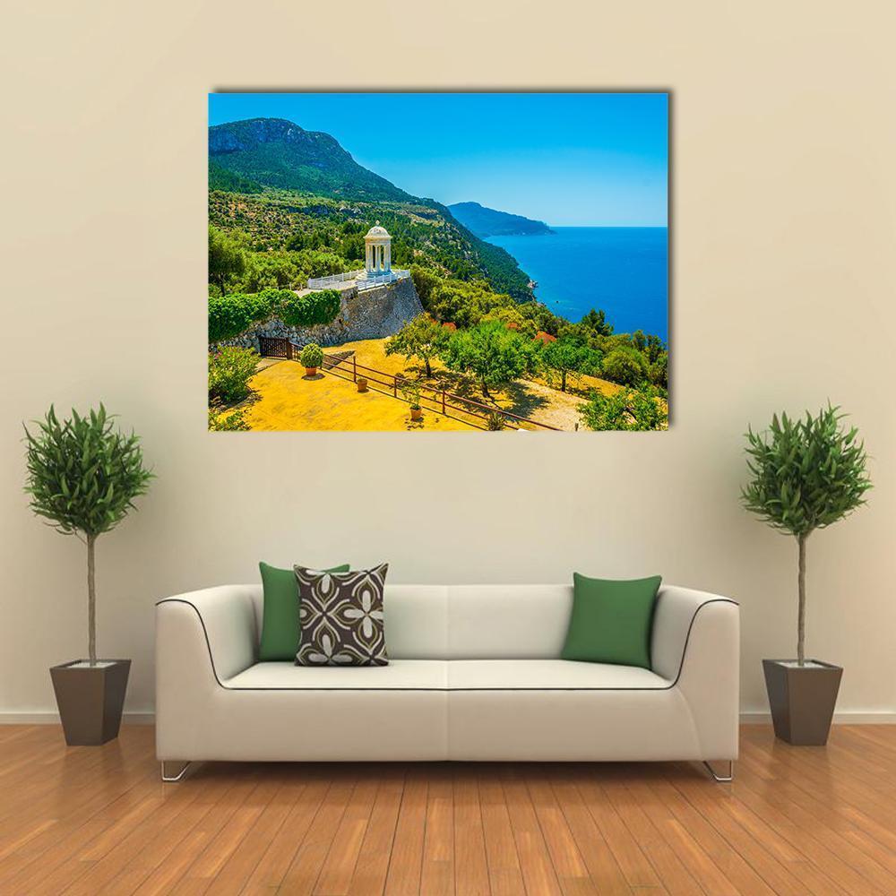 White Gazebo by the Ocean Canvas Wall Art in yellow, green and blue, single panel hung on a wall