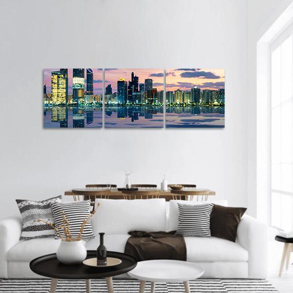 Abu Dhabi Skyline at Sunset Panoramic Canvas Wall Art in yellow, blue and pink, hung on a wall