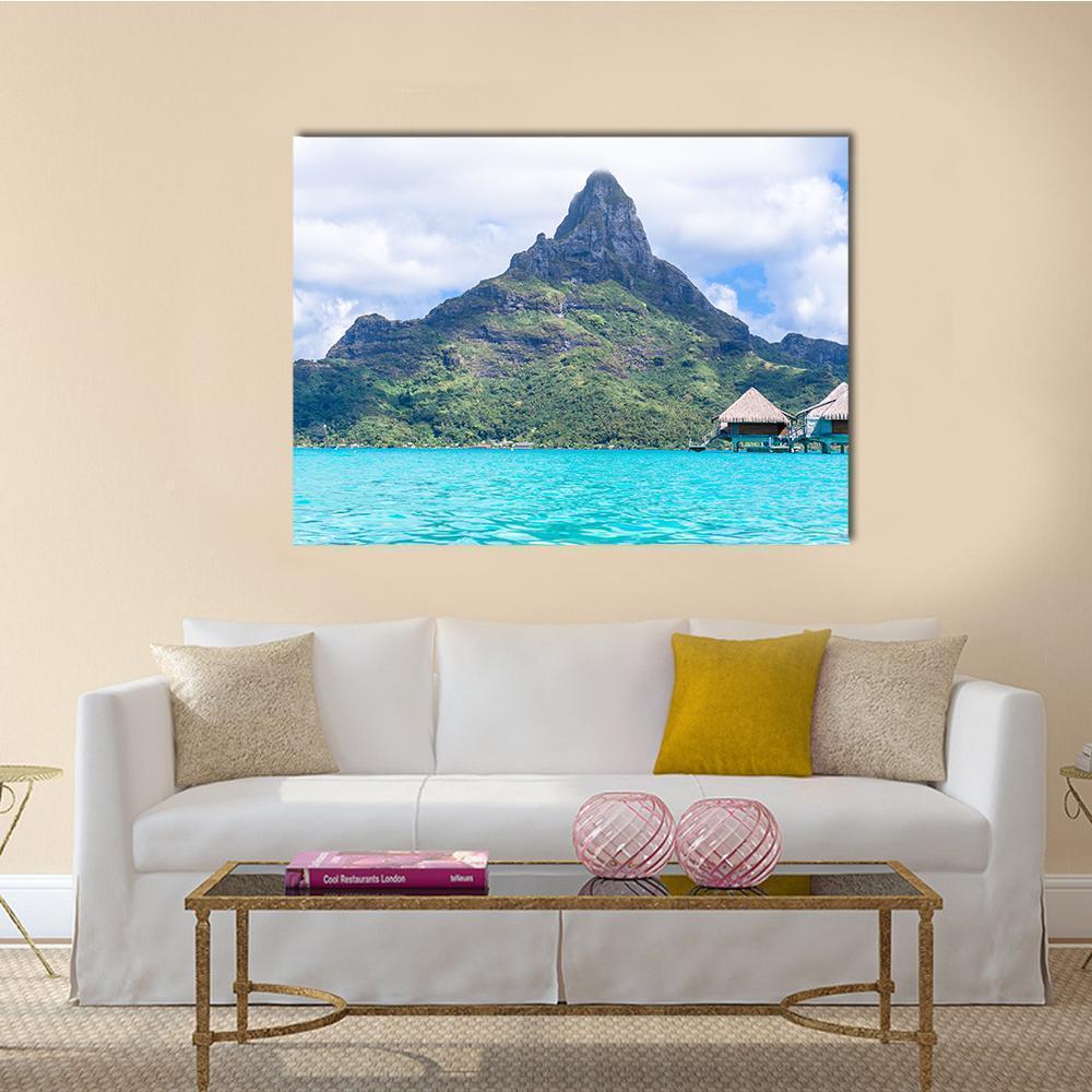 Turquoise Lagoon with Overwater Bungalows and Peak Canvas Wall Art in white, green and blue, single panel hung on a wall