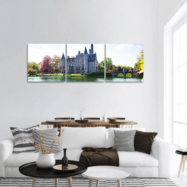 Bornem Castle Reflected in Calm Lake Panoramic Canvas Wall Art in gray, green and blue, hung on a wall